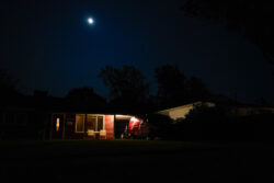 LEAVE THE LIGHT ON: Under the bright moon, a single home is lit up for the evening, welcoming its inhabitants home.